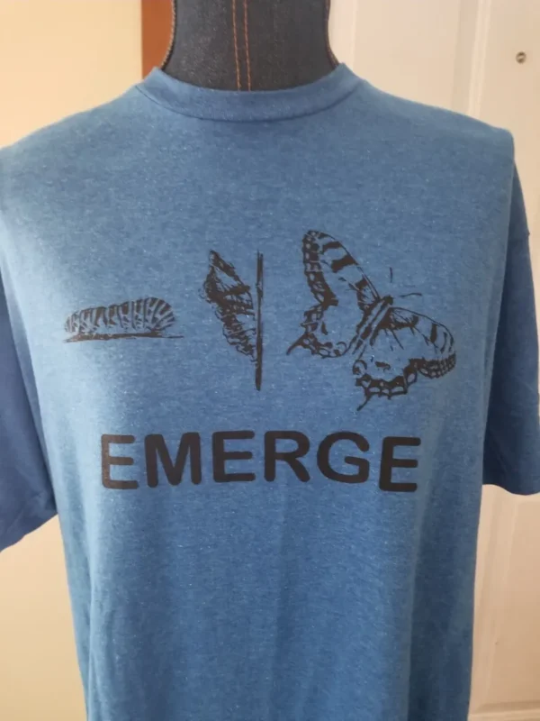 A blue shirt with the word emerge written on it.