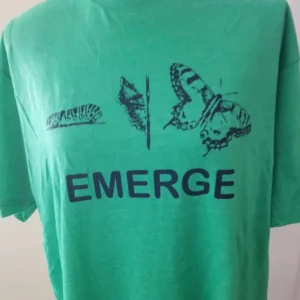 A green shirt with the word emerge written on it.