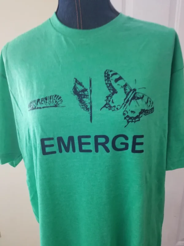 A green shirt with the word emerge written on it.