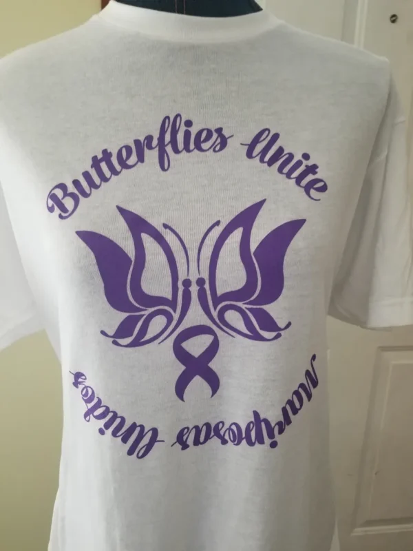 A white shirt with purple lettering and an image of a butterfly.