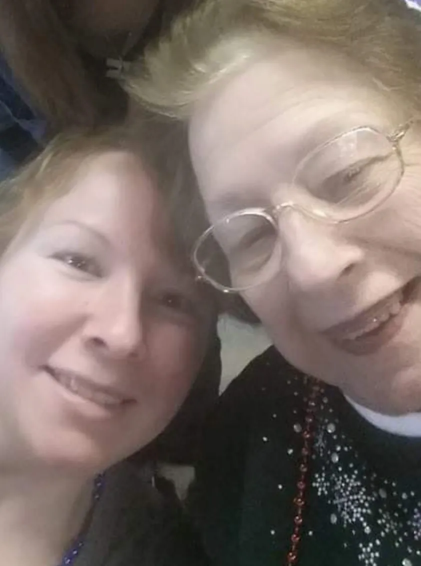 Two women smiling close up portrait.