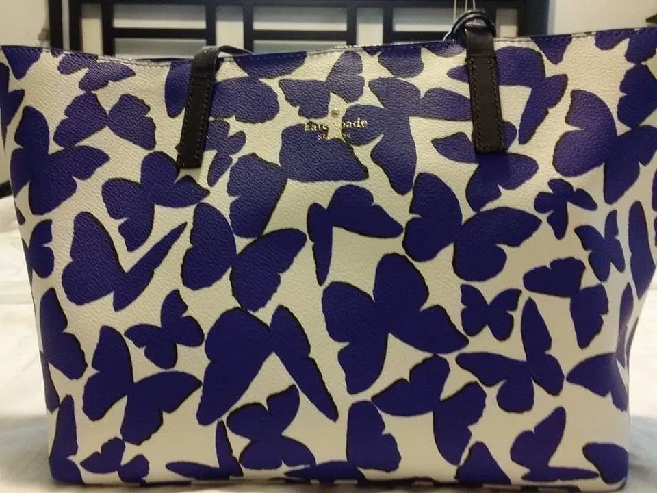 White tote bag with blue butterfly pattern.