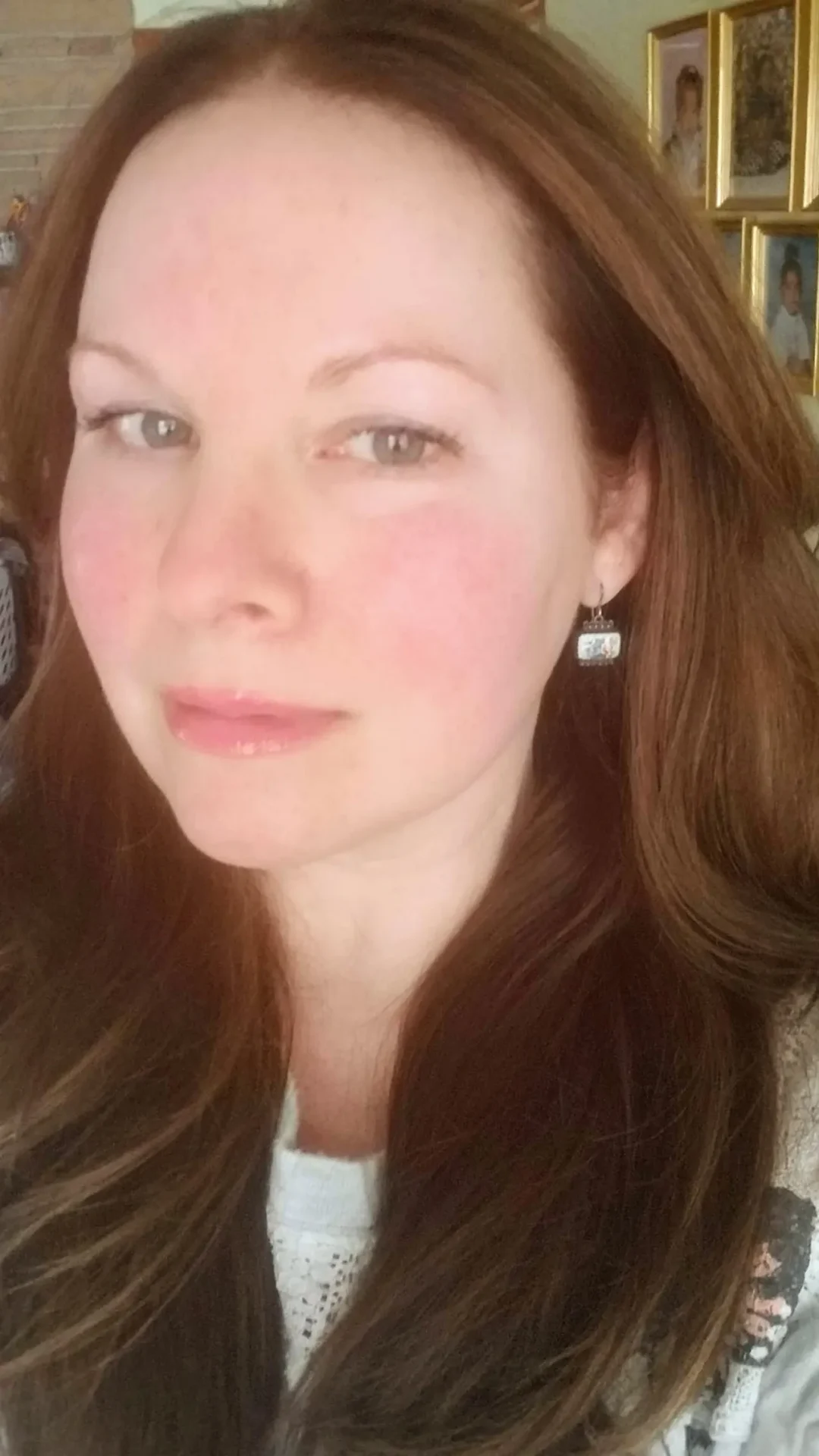 Woman with brown hair wearing an earring.