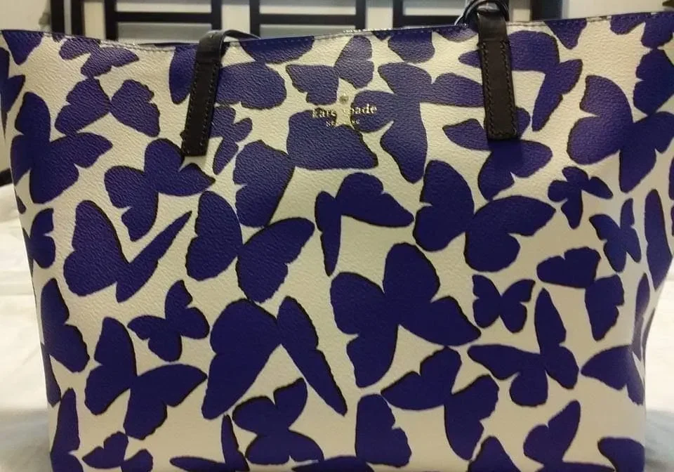 White tote bag with blue butterfly pattern.