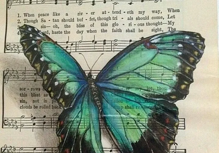 Blue butterfly on sheet music.